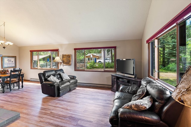 159 Sylvan Dr, Bigfork, MT 59911 - living area featuring lofted ceiling, baseboard heating, a chandelier, and light wood-style floors