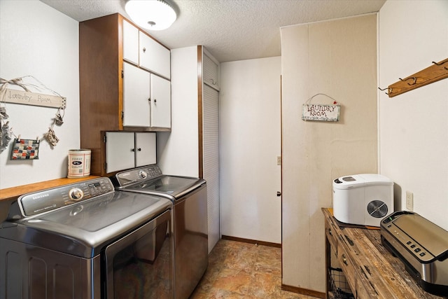 159 Sylvan Dr, Bigfork, MT 59911 - laundry room with cabinet space, washing machine and dryer, a textured ceiling, and stone finish floors