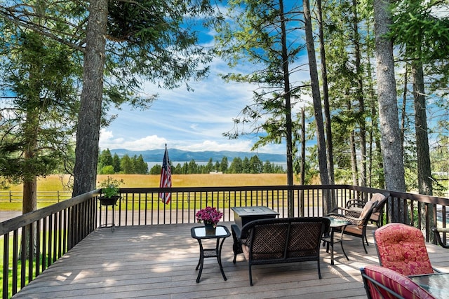 159 Sylvan Dr, Bigfork, MT 59911 - wooden terrace with a mountain view and an outdoor living space