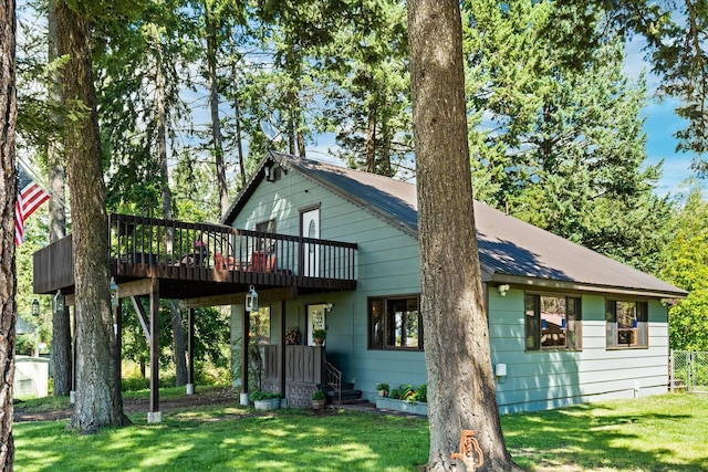 159 Sylvan Dr, Bigfork, MT 59911 - back of property featuring a yard, a deck, and a metal roof