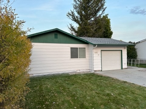 view of home's exterior featuring a yard and a garage