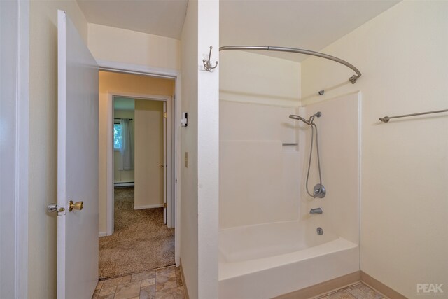 bathroom with a baseboard radiator and bathtub / shower combination