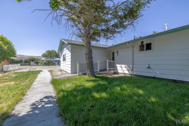 rear view of house featuring a lawn