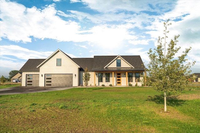 view of front of house with a garage, covered porch, and a front yard