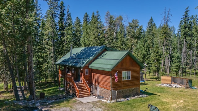 log cabin with a front lawn