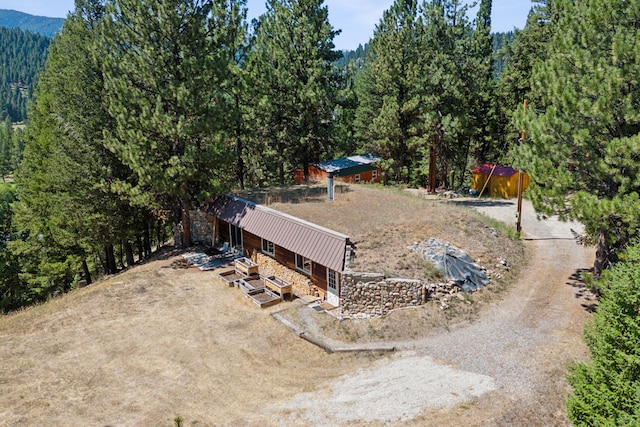 birds eye view of property featuring a wooded view