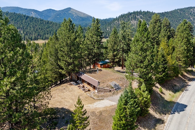 drone / aerial view with a forest view and a mountain view