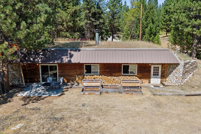 view of front facade featuring metal roof and stone siding