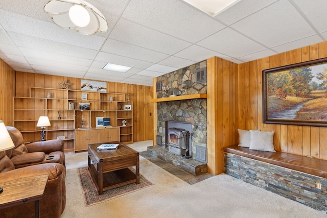 carpeted living room featuring wooden walls