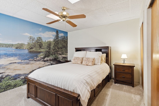 bedroom with a ceiling fan and light carpet