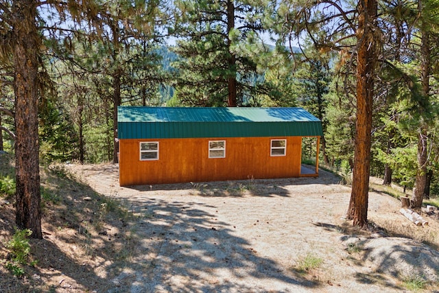 view of side of property with metal roof