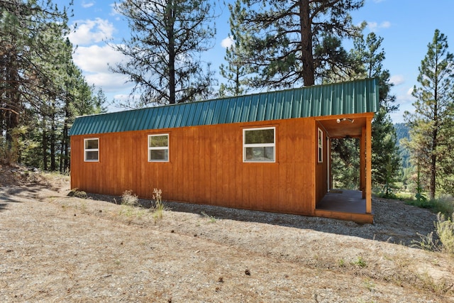 view of side of home with metal roof