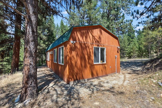 view of side of property featuring a gambrel roof