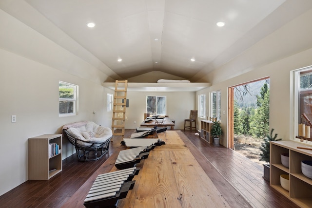 workout room featuring dark wood-style flooring, lofted ceiling, recessed lighting, and a healthy amount of sunlight