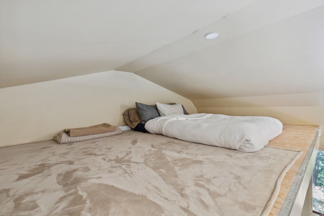 bedroom with lofted ceiling and carpet floors