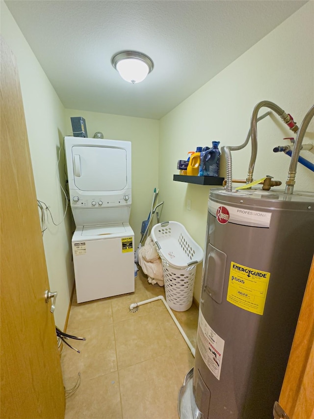 washroom featuring light tile patterned flooring, electric water heater, and stacked washing maching and dryer