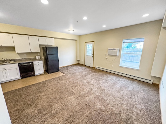 kitchen featuring white cabinetry, light colored carpet, black appliances, and a baseboard heating unit