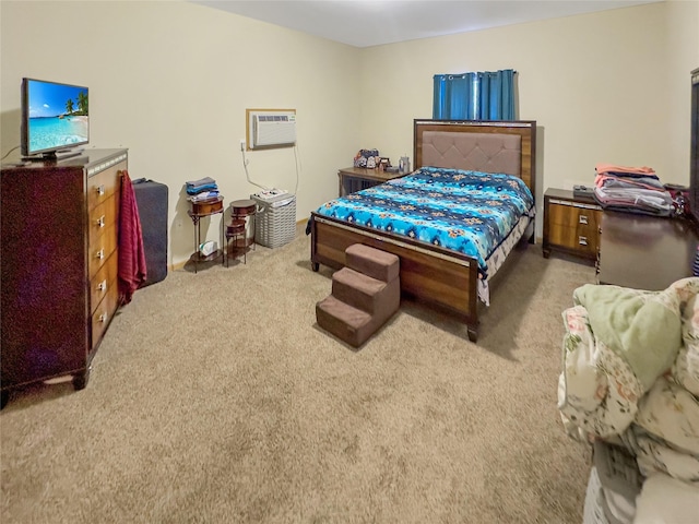 bedroom with an AC wall unit and light colored carpet