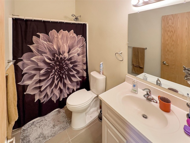 bathroom featuring vanity, toilet, and tile patterned flooring