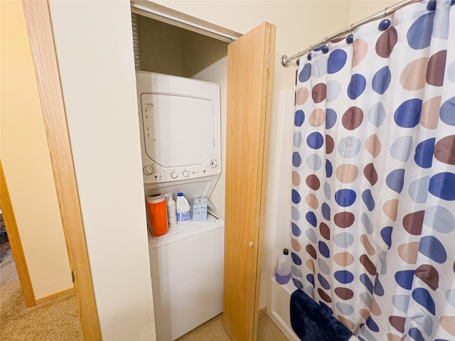 washroom with stacked washer / drying machine