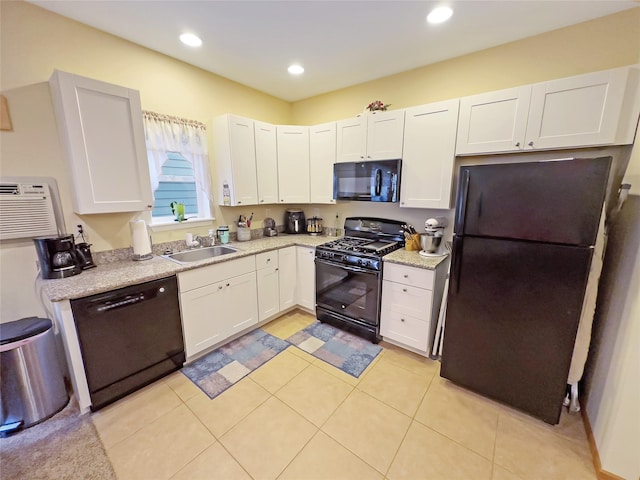 kitchen with white cabinetry, sink, light tile patterned floors, and black appliances