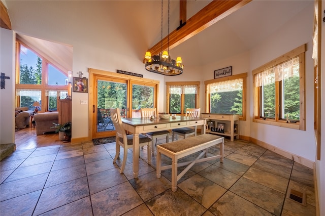 tiled dining space with high vaulted ceiling, a chandelier, and a healthy amount of sunlight