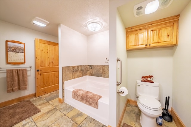 bathroom with toilet, a bath, and tile patterned floors