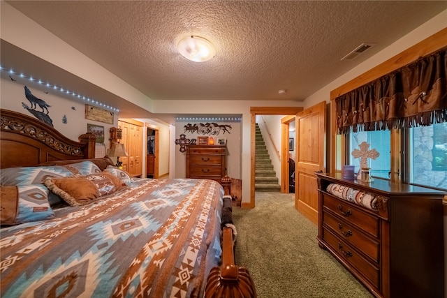 carpeted bedroom with a textured ceiling