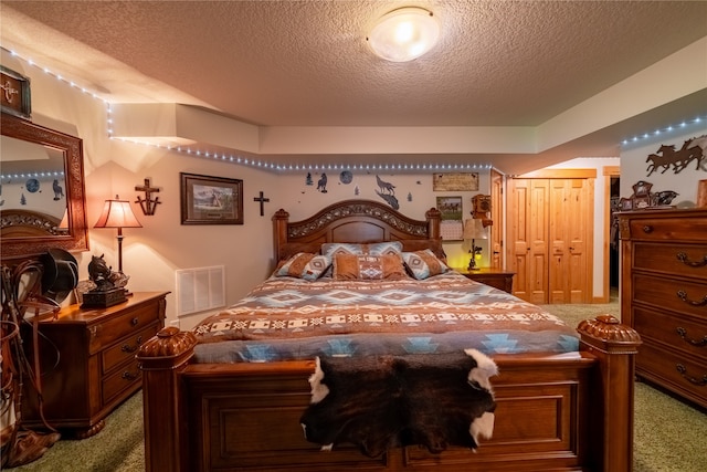 carpeted bedroom with a textured ceiling and a closet