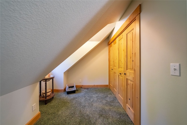 bonus room with carpet flooring, a textured ceiling, and lofted ceiling