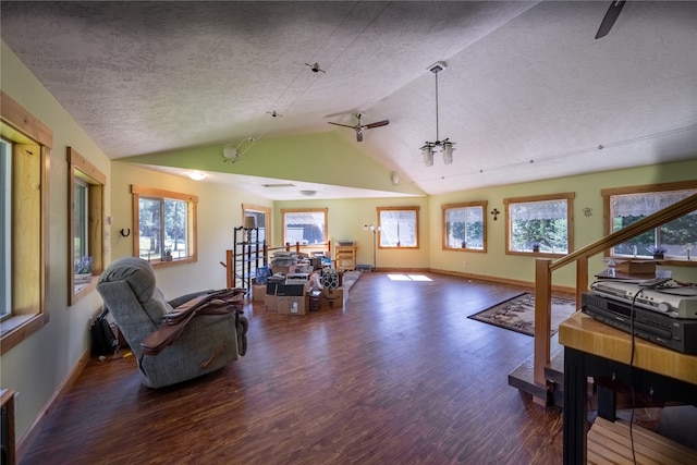 interior space featuring ceiling fan, dark wood-type flooring, a textured ceiling, and lofted ceiling