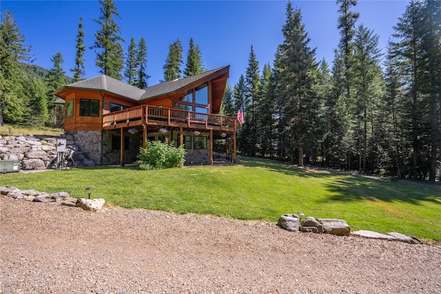 back of property featuring a deck and a yard