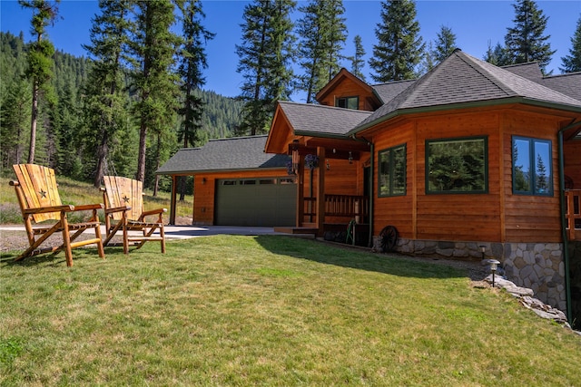 view of side of home with a garage and a lawn