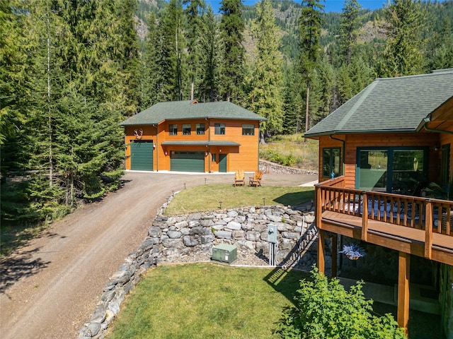 exterior space featuring a wooden deck and a garage