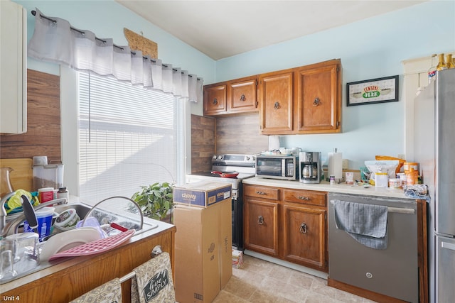 kitchen featuring appliances with stainless steel finishes, washer / clothes dryer, and light tile patterned floors