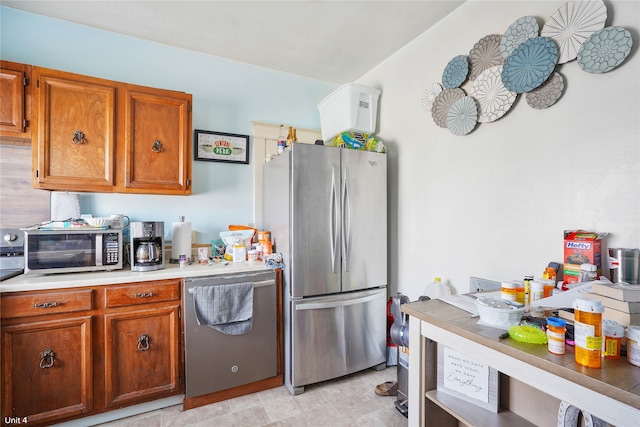 kitchen with appliances with stainless steel finishes and light tile patterned floors