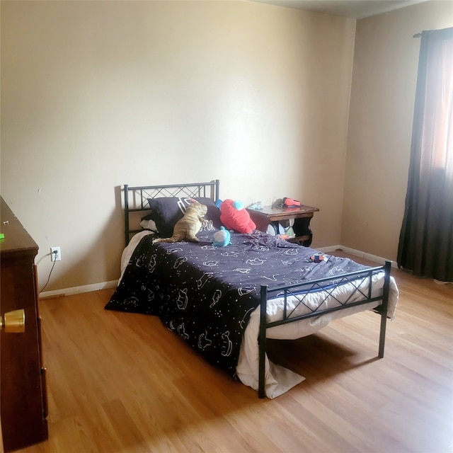 bedroom with light hardwood / wood-style flooring