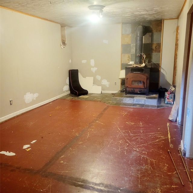 interior space with a wood stove, heating unit, and a textured ceiling