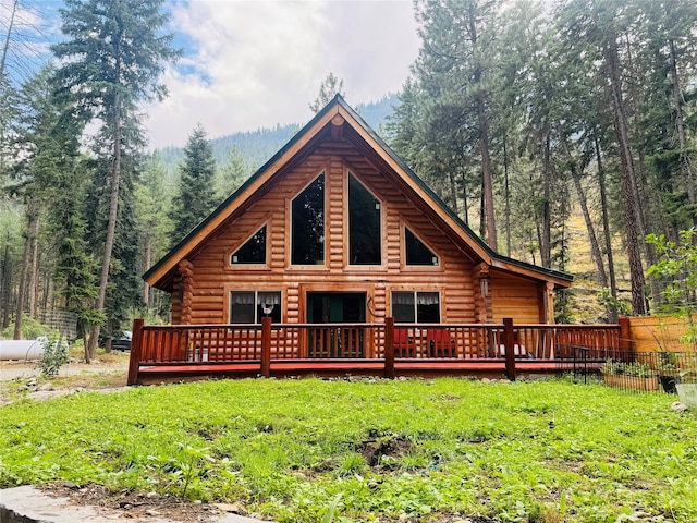 view of front of house with a front lawn and a deck