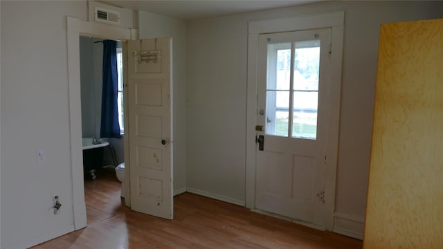 doorway with light wood-type flooring