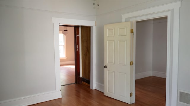 corridor featuring wood-type flooring