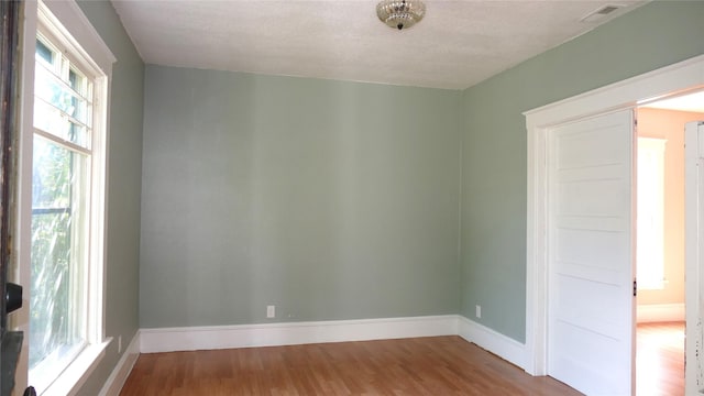 spare room with wood-type flooring and a textured ceiling