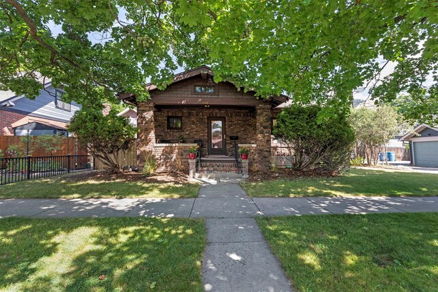 view of front of house with a garage and a front lawn