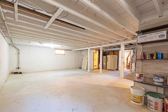 basement featuring secured water heater and refrigerator