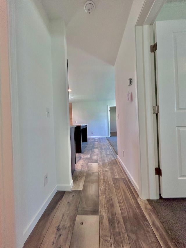 corridor with dark hardwood / wood-style flooring