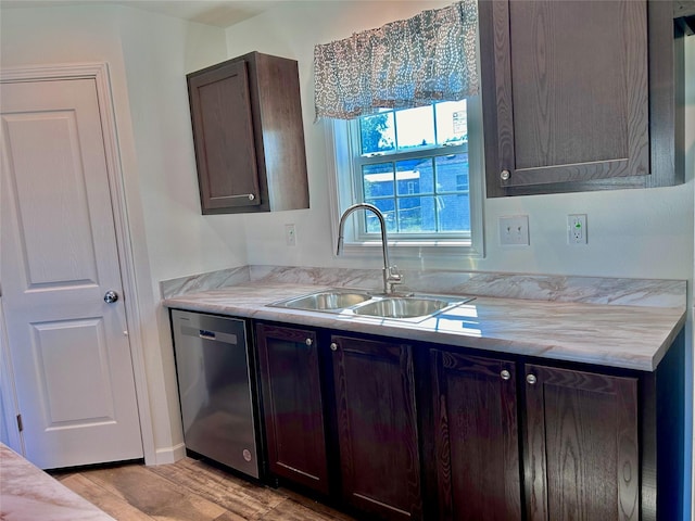 kitchen with stainless steel dishwasher, sink, dark brown cabinets, and light hardwood / wood-style flooring