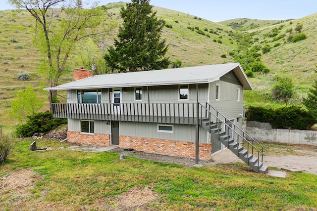 rear view of house featuring a mountain view