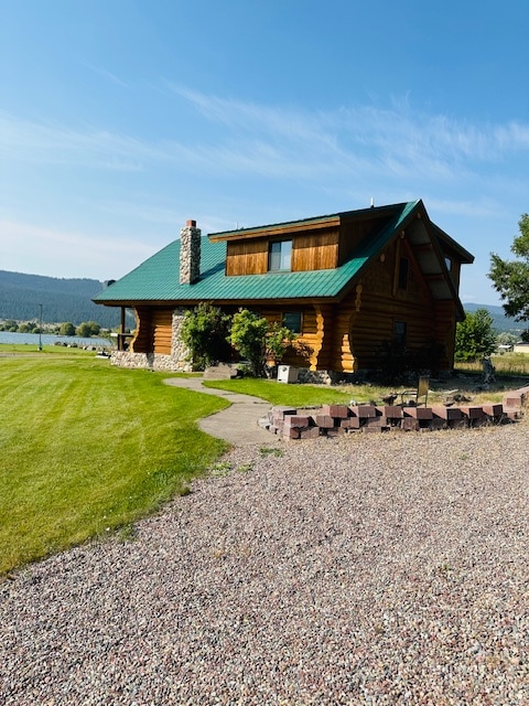 view of front of house featuring a front yard and a water view