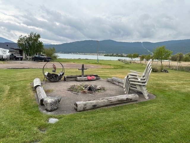 exterior space with a water and mountain view