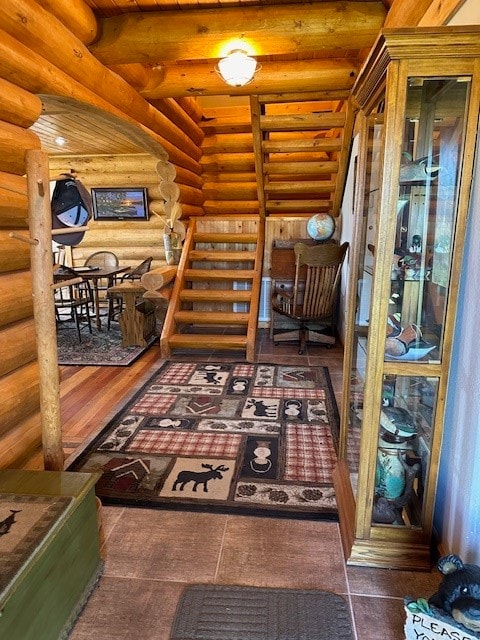 living area with log walls and dark hardwood / wood-style floors